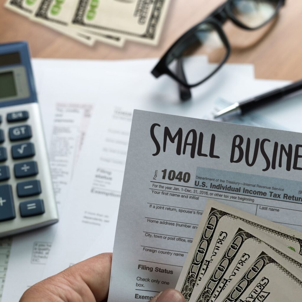 Small business owner reviewing a US tax return and financial documents