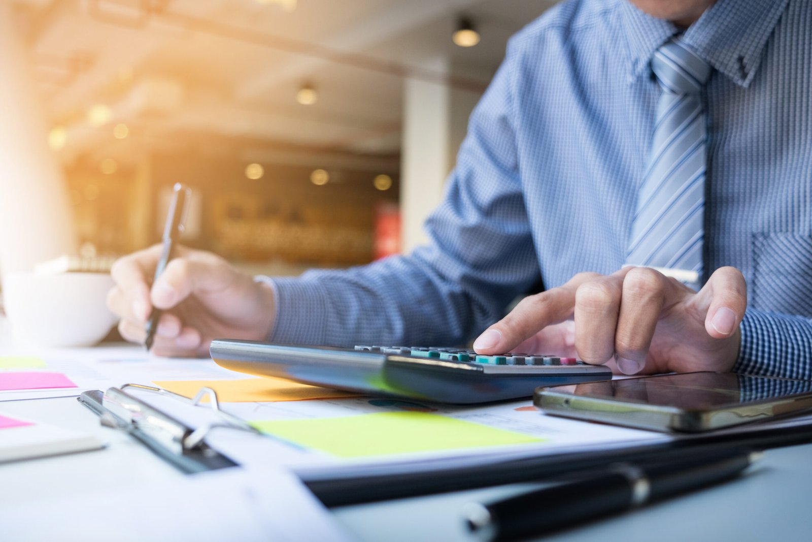 Accounting company professional reviewing financial records with calculator